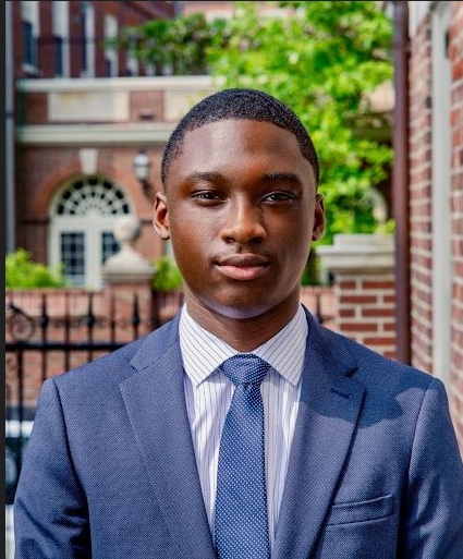 Christopher Lambry of Alpha Phi Alpha Fraternity, Inc. at Morehouse College, wearing a light blue suit and blue tie
